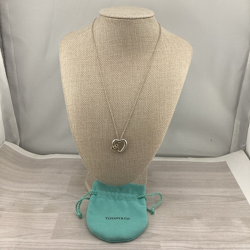 Tiffany & Co. 9.25 S.Silver with 750 Yellow Gold Bow Heart Pendant Necklace.